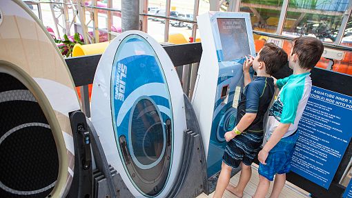 Water-Zoo Clinton Slideboarder Two boys checking their Slideboarder scores on a screen at the Water-Zoo Indoor water park in Clinton, Oklahoma