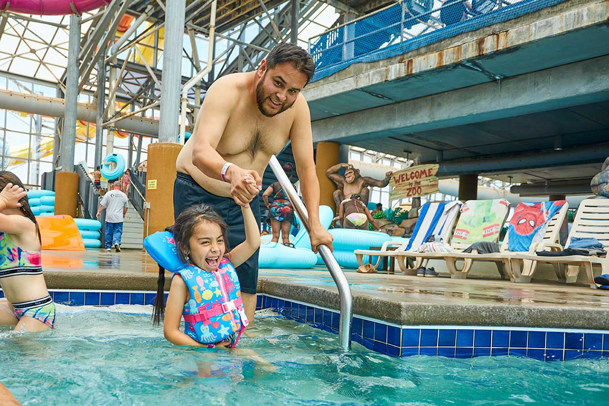 Father-Friday Happy father and daughter on a slide tube at Water-Zoo indoor water park in Clinton, Oklahoma